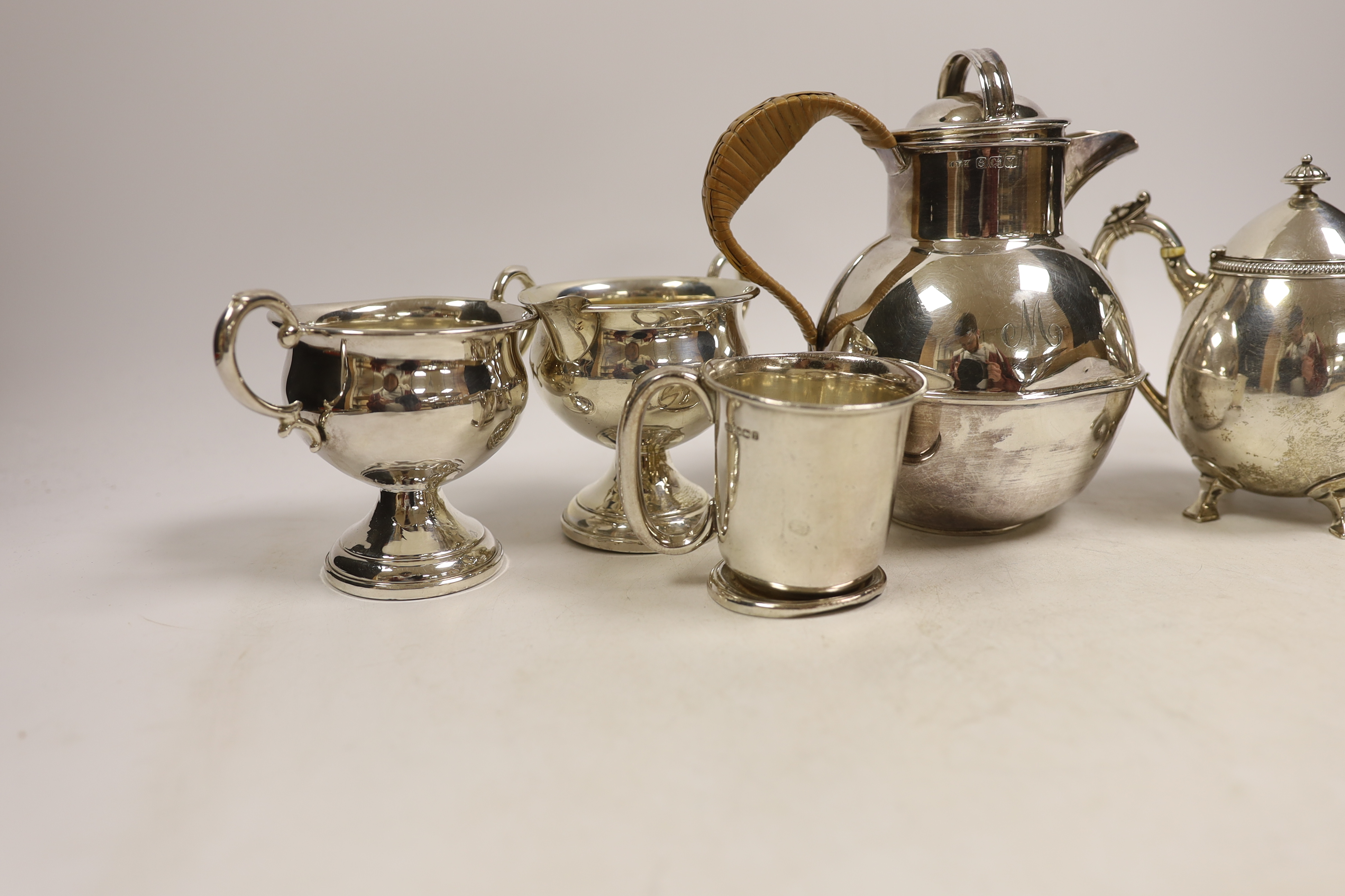 An Elizabeth II silver 'Guernsey' milk can, Kenneth Tyler Key, Birmingham, 1966, height 16.4cm, a sterling bachelor's teapot, sterling cream and sugar (weighted?) and a silver christening mug, gross weight 27.2oz. CITES